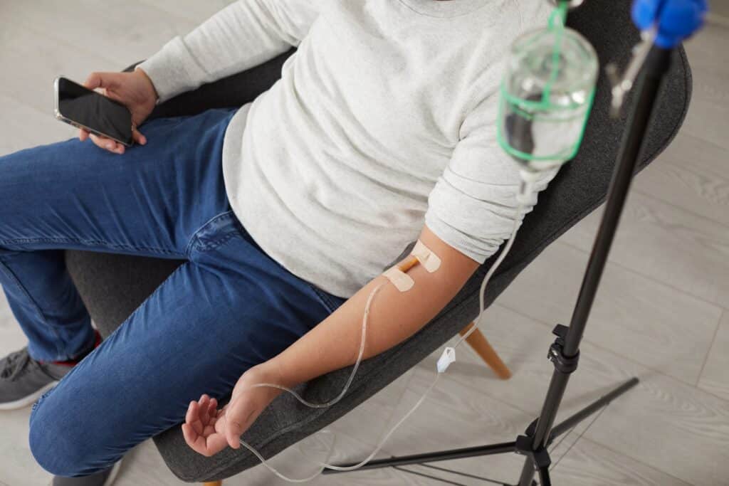 Close up of a man getting IV therapy to improve his brain wellness