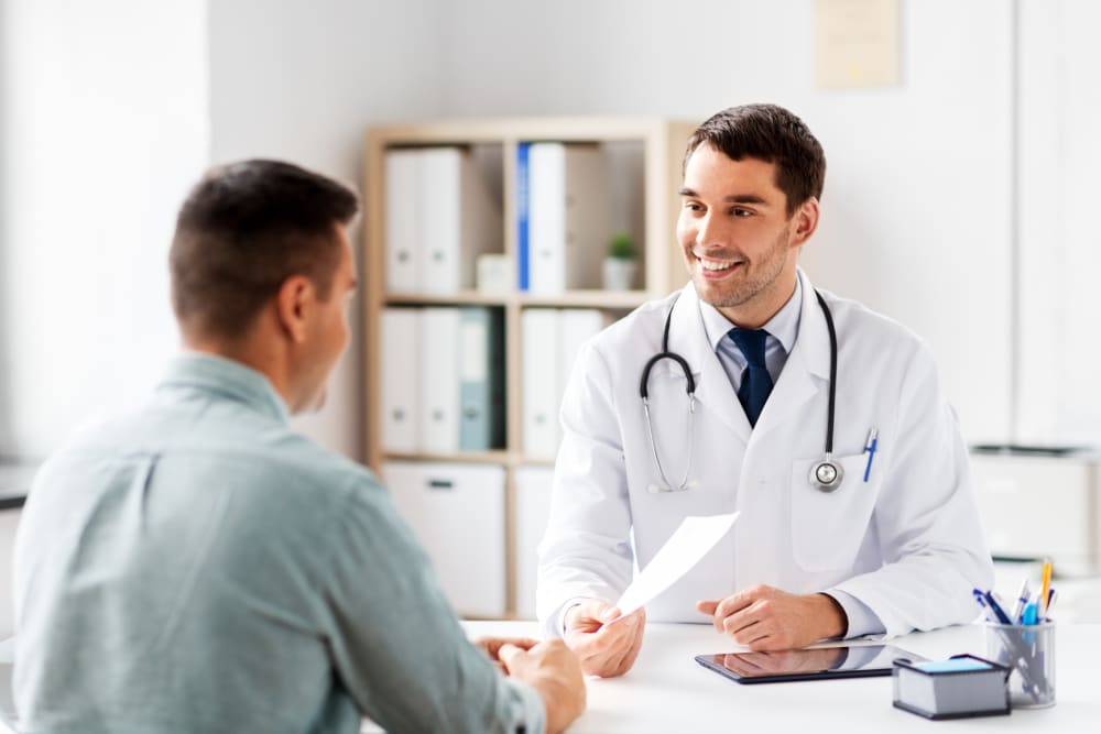 Doctor and patient having a friendly one-on-one consultation built on trust from their doctor and patient relationship.