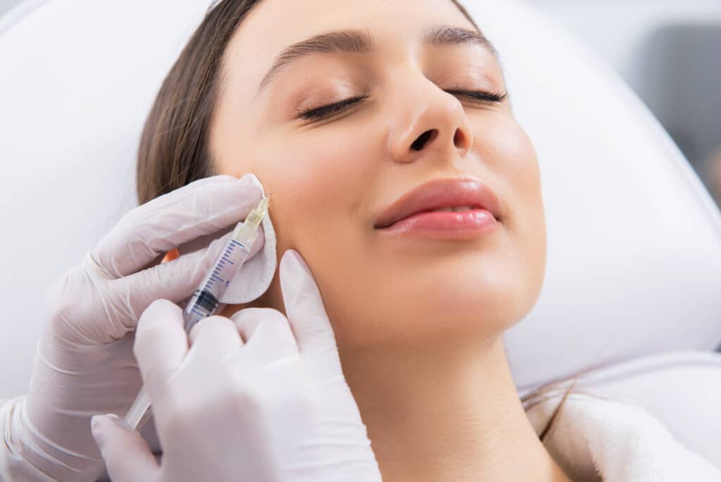 Young woman getting "baby Botox" injections for subtle enhancement and maintaining a youthful look