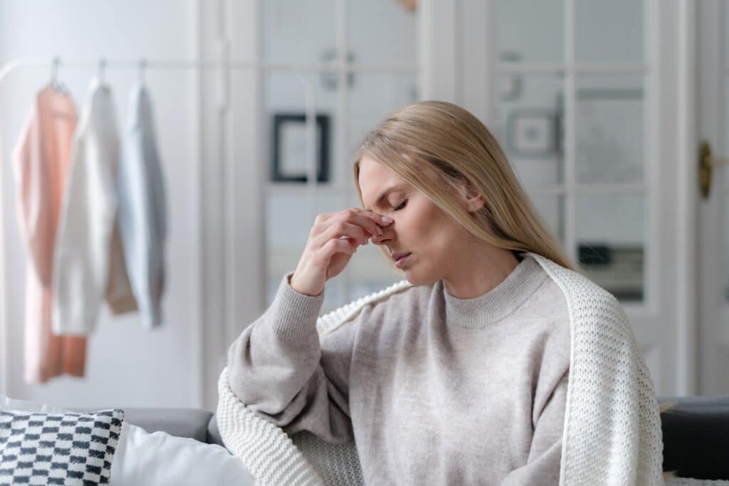 Young woman suffering from chronic fatigue and in need of NAD+ treatment